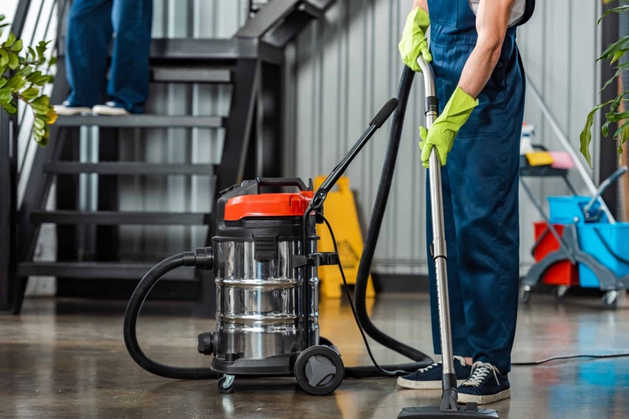 cropped-view-of-cleaner-in-uniform-cleaning-floor-with-vacuum-cleaner